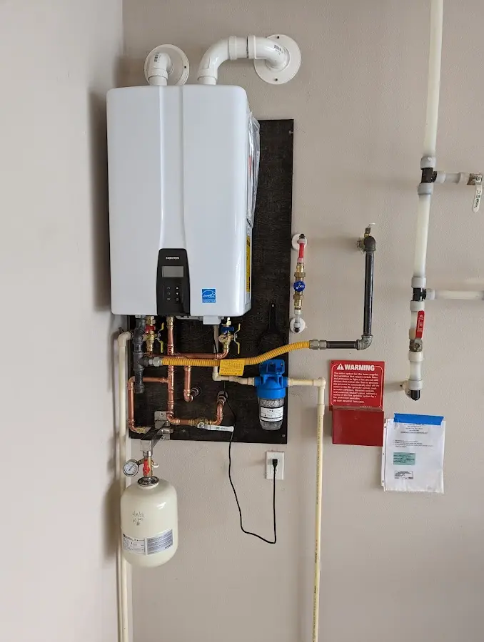 Professional plumber installing copper piping in a Dawsonville home